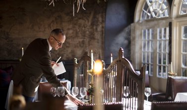 Dining table being set at The Witchery restaurant for The Royal Edinburgh Military Tattoo hospitality package