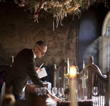Dining table being set at The Witchery restaurant for The Royal Edinburgh Military Tattoo hospitality package