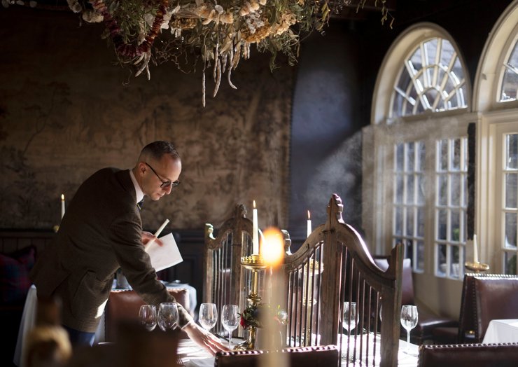 Dining table being set at The Witchery restaurant for The Royal Edinburgh Military Tattoo hospitality package