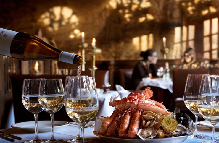 Dinner being served as part of the hospitality package at The Witchery restaurant at The Royal Edinburgh Military Tattoo